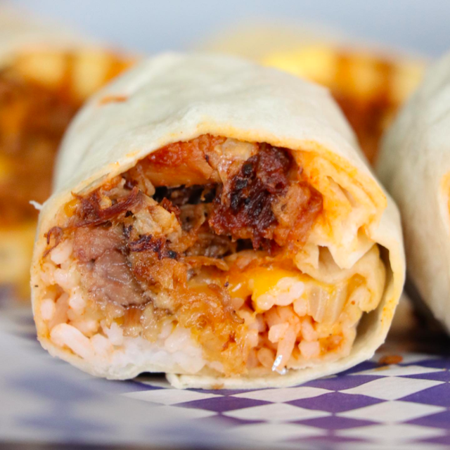 close up of kalua pig-filled bomber (breakfast burrito) from Kono's. Kono's cooks their kalua pig for 12 hours, so that way it's nice and tender. Trying it is one of the best things to do in Kailua.