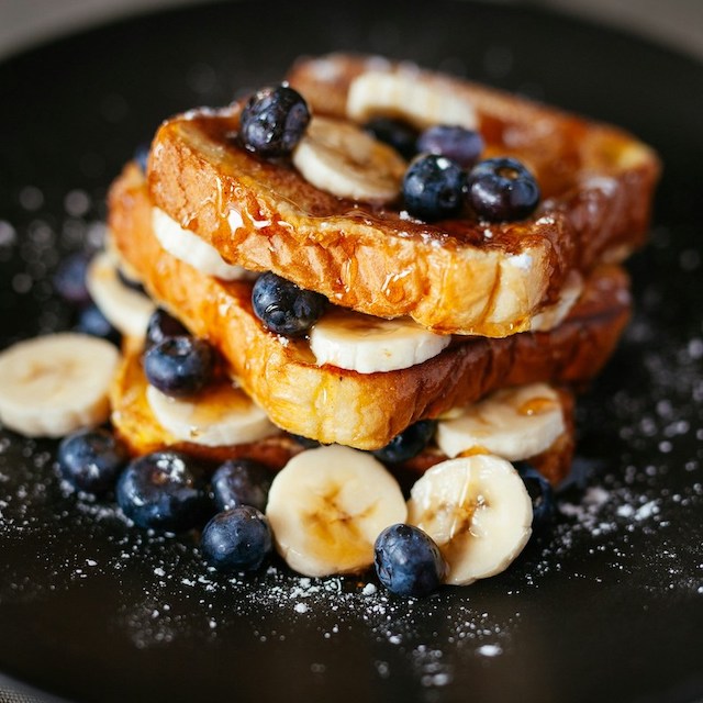 A towering plate of French toast with banana slices, blueberries, and maple syrup. If you're looking for a kid-friendly breakfast in Ko Olina -- one that serves up delicious French toast -- check out Off the Hook at Disney's Aulani hotel.